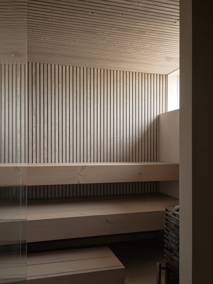 The property also features a detached outdoor sauna, adding both luxury and functionality to everyday living. Its exterior cladding matches the main building with Luna Trim panels, and the terrace features the same brushed Luna SHP Profix 3 ThermoWood® spruce decking. Both products are characterized by small, round knots that contribute to a warm and natural appearance.For the interior tone of the sauna, the aim was to create a naturally weathered grey look — achieved with Luna Arctic Triple panels, suitable for both interior and exterior use. The benches are made from wide Luna SHP 40x185 boards, toned in NCS S 4502-R, creating a cohesive and serene atmosphere.